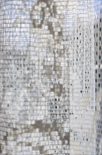 Vertical close-up image of a white translucent curtain with embroidery details, AI generated