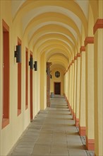 Yellow arcade from inside with archways and pillars, University, Lower Castle built 17th century,