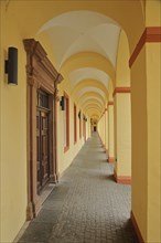 Yellow arcade from inside with archways and pillars, University, Lower Castle built 17th century,