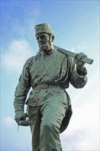 Miner Henner with pickaxe by Friedrich Reusch 1902, symbol for miner in mining, mine, worker,