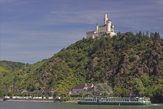 A castle on a green hill, on the bank of a river, with a ship in the foreground, Middle Ages,