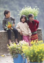 Vietnamese children selling flowers in the northern mountains, Ha Giang province, Vietnam, Asia