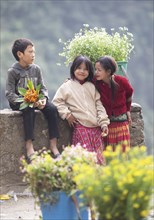 Vietnamese children selling flowers in the northern mountains, Ha Giang province, Vietnam, Asia