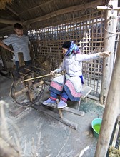 Vietnamese woman from the Hmong minority making linen, Lung Tam linen weaving mill, Ha Giang