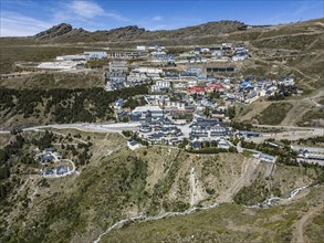 Aerial view of a snow-covered mountain resort with modern buildings and streets, aerial view,