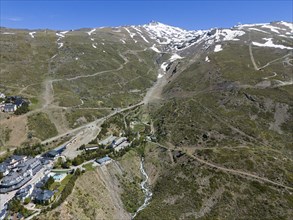 Aerial view of a mountain area with snow-covered peaks and hiking trails, aerial view, Pradollano,