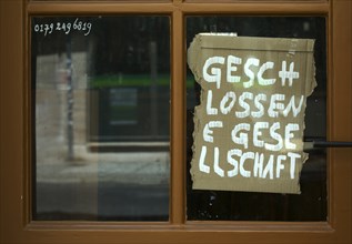 Closed society sign on window, Weimar, Thuringia, Germany, Europe