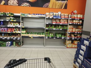 Rice shelves in a supermarket emptied by supply shortages and hoarding purchases