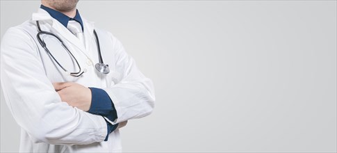 Banner of unrecognizable doctor with crossed arms with space for text. Crossed arms doctor medical