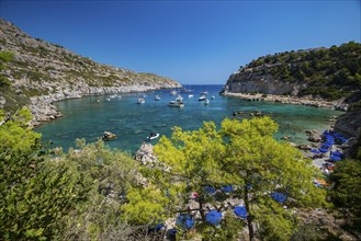 Beach umbrellas and sunbeds, turquoise waters, Anthony Quinn Bay, Faliraki, Rhodes, Dodecanese,