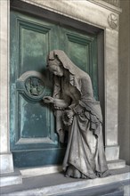 Sculpture of an old woman at a door with an hourglass, Monumental Cemetery, Cimitero monumentale di