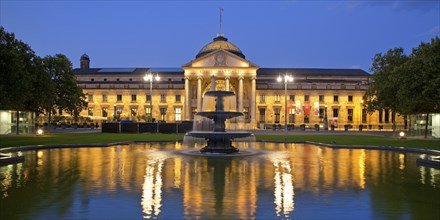 Illuminated spa hotel and Casino in the evening with cascade fountain, Wiesbaden, Hesse, Germany,