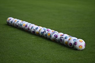 20 Adidas Derbystar match balls lie on grass, PreZero Arena, Sinsheim, Baden-Württemberg, Germany,