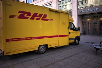 DHL delivery vehicle, logo, parked in front of Primark department stores' chain, KönigsstraÃŸe,