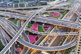 Intersection of Sheikh Zayed Road traffic on the road near the Burj Khalifa with Metro in Dubai,