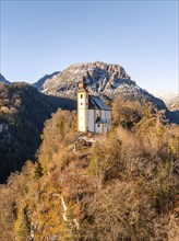 Isolated church in the snow with a clear blue sky and mountains, St Pankraz, Karlstein, Bad