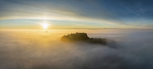 Aerial view of the Hegau volcano Hohentwiel with the upper fortress ruins as a silhouette at