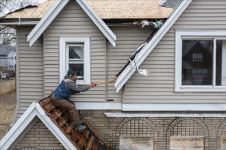 Detroit, Michigan, Workers replace a roof on a vacant house in the Morningside neighborhood. They