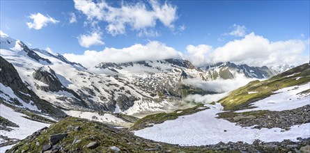 Mountain landscape with snow fields and high fog in the valley, summit Hoher WeiÃŸzint and