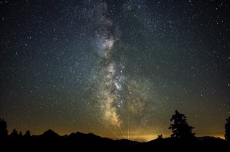 Milky Way over the Chiemgau Alps with the Sonntagshorn, the rays on the horizon seem to come from a