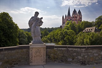 Statue of the bridge saint Nepomuk on the Old Lahn Bridge with Limburg Cathedral St. George,