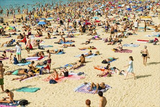 Crowded beach with people in August, San Sebastian, Donostia, Basque Country, Northern Spain,