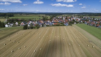 Aerial view of straw bales on a harvested grain field near a village west of Augsburg, Bavaria,