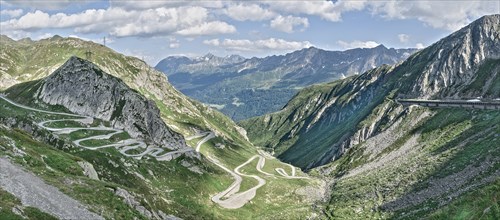 Panoramic view photo with reduced saturation on left Tremola southern historic driveway from Airolo