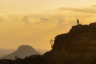 Climbers on the Schrammsteine in the Elbe Sandstone Mountains with the Lilienstein in the