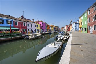 Colourful houses on the canal with reflection, Canal with boats and colourful house facades, Burano