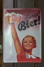 Beer advertising on a metal sign from the 1950s in a beer garden, Bavaria, Germany, Europe