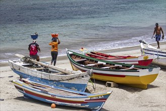 Two local Cape Verdean women transporting food on their heads on the beach near Tarrafa on the