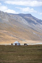 Yurt and horse in the mountains, barren landscape, Burkhan Valley, Tien Shan, Issyk Kul Province,