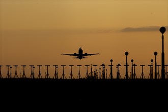 Boeing 737 aircraft taking off at sunset from London Stansted airport, Essex, England, United