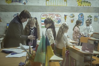 Pupils in a classroom in one of the metro schools in Kharkiv. Classrooms were set up in various