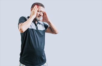 Senior man with headache isolated. Senior person with migraine holding his head isolated