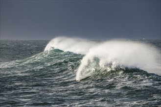 Big wave breaks in the open sea on the Breton coast near Brest, France, Europe