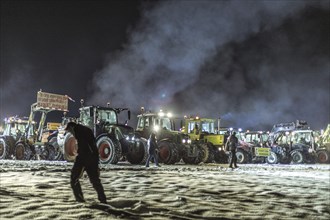 Tractors during a rally as part of the farmers' protests on the snow-covered Kirchbichl,