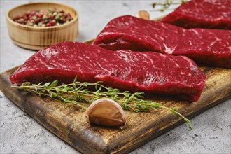 Closeup view of raw strip steak boneless on cutting board