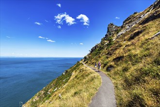 Walkers on South West Coast Path, coastal path, Valley of the Rocks, rocky coast in Exmoor National