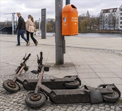 Rusty electric scooters on public streets, East Side Galery in Berlin-Mitte, Berlin, Germany,