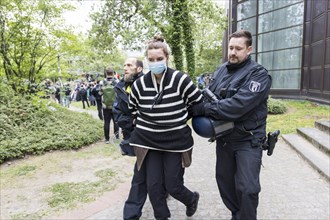 An activist is taken away by the police during the occupation of the courtyard of the Free