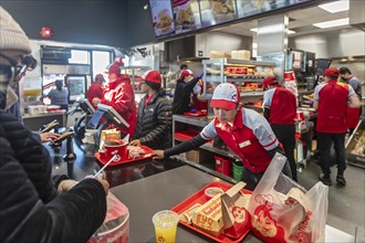 Sterling Heights, Michigan, Workers serve up Chickenjoy fried chicken at Jollibee, a Filipino fast