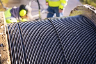 Detailed view of the cable spool on a machine reel with focus on the cables, fibre optic