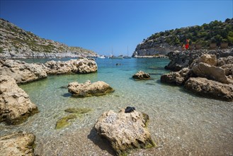 Beach umbrellas and sunbeds, turquoise waters, Anthony Quinn Bay, Faliraki, Rhodes, Dodecanese,