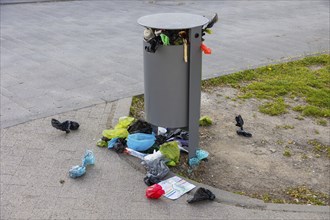 Public waste bin at leipzig city harbour, completely overcrowded, pet owners throw their dog waste