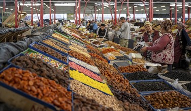 Vendor selling sweets, dried fruit and nuts, market stall at the Osh Bazaar, Bishkek, Kyrgyzstan,