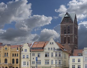 House facades on the market square, in the back the remaining tower of St. Mary's Church, Wismar,