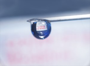 Macro image Covid vaccine, a drop of Moderna vaccine hangs on a vaccine needle