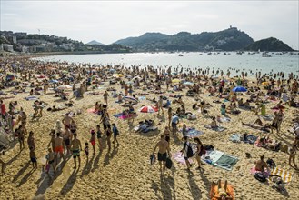 Crowded beach with people in August, San Sebastian, Donostia, Basque Country, Northern Spain,